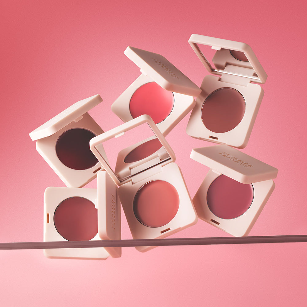 Compact blushes in various shades on a pink background