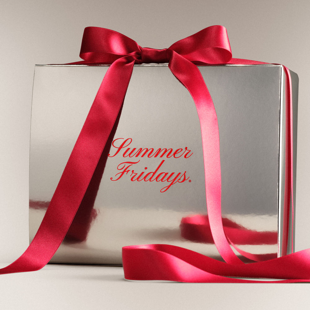 Silver gift box with a red ribbon and 'Summer Fridays' text on a light background
