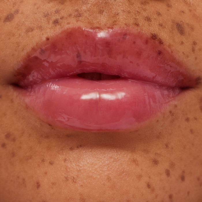 Close-up of glossy pink lips